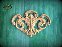 Load image into Gallery viewer, a wood carving of an ornate design on a green background