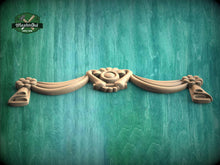 Load image into Gallery viewer, A wooden carving of a heart-shaped design is displayed against a green wooden background.