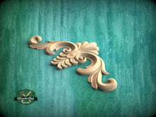 Load image into Gallery viewer, a wood carving of a flower on a green background