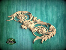 Load image into Gallery viewer, A decorative wooden carving with intricate floral and leaf-like patterns is displayed against a green background.