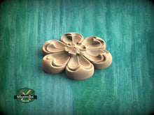 Load image into Gallery viewer, A wooden flower-shaped object is displayed against a green background.