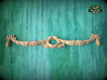 Load image into Gallery viewer, A decorative wooden mold or sculpture is displayed against a green textured background.