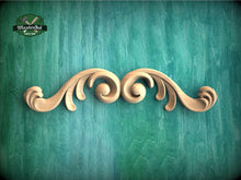Load image into Gallery viewer, a wooden carving of a swirl on a green background