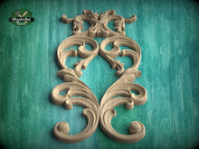 Load image into Gallery viewer, an ornate, carved wooden design with intricate scrollwork and floral patterns, set against a teal background.