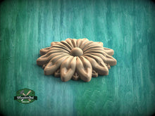 Load image into Gallery viewer, A wooden flower-shaped object is displayed against a green background.