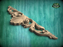 Load image into Gallery viewer, A decorative wooden carving with intricate floral and scrollwork designs is displayed against a green background.