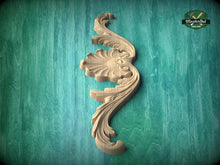 Load image into Gallery viewer, A decorative wooden carving in the shape of a flower or leaf is displayed against a green textured background.