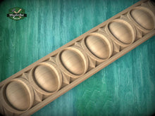Load image into Gallery viewer, A wooden decorative border with a repeating pattern of oval shapes is displayed against a green background.