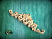 Load image into Gallery viewer, A decorative wooden carving with intricate scrollwork and floral elements is displayed against a green textured background.