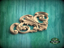Load image into Gallery viewer, a wood carving of an ornate design on a green background