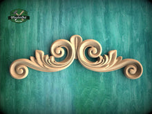 Load image into Gallery viewer, A decorative wooden scrollwork piece is displayed against a green textured background.