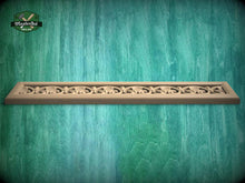 Load image into Gallery viewer, A decorative wooden frame with an intricate floral pattern is displayed against a textured green background.