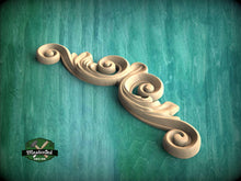 Load image into Gallery viewer, A decorative wooden scroll or ornament with a swirling, curving design is displayed against a teal-colored background.