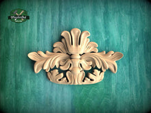 Load image into Gallery viewer, a decorative wooden carving on a green background.