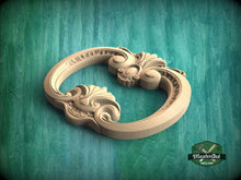 Load image into Gallery viewer, A wooden carving of an ornate, decorative handle or faucet is displayed against a green background.
