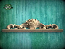Load image into Gallery viewer, A decorative wooden shelf or cabinet with an ornate, scroll-like design on the front, set against a green textured background.