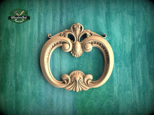 Load image into Gallery viewer, an ornate, carved wooden frame with intricate designs, set against a green background.