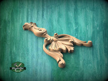 Load image into Gallery viewer, A wooden carving of a stylized bird or bird-like figure is displayed against a green background.