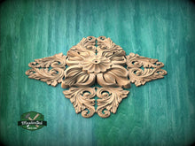 Load image into Gallery viewer, a decorative wooden piece with intricate carvings, displayed against a green wooden background.