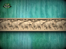 Load image into Gallery viewer, a carved wooden elephant design on a green background.