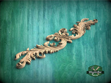 Load image into Gallery viewer, a wood carving of a flower on a green background