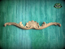 Load image into Gallery viewer, A decorative wooden carving with a shell-like design is displayed against a teal-colored background.