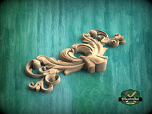 Load image into Gallery viewer, A decorative wooden carving with intricate scrollwork is displayed against a teal background.