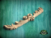 Load image into Gallery viewer, a wood carving of a flower on a green background