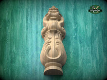 Load image into Gallery viewer, A wooden carving of a stylized flower or plant is displayed against a green background.