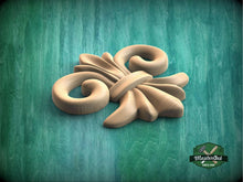 Load image into Gallery viewer, a wooden object sitting on top of a green surface