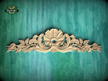 Load image into Gallery viewer, a decorative wooden carving on a green background.