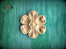 Load image into Gallery viewer, A wooden flower-shaped carving is prominently displayed against a green background.