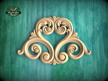 Load image into Gallery viewer, an ornate, carved wooden design with intricate scrollwork and floral patterns, set against a green background.