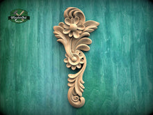 Load image into Gallery viewer, a decorative wooden carving of a flower on a green background.
