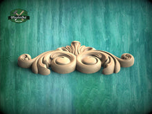 Load image into Gallery viewer, A decorative wooden carving with an ornate, swirling design is displayed against a green wooden background.