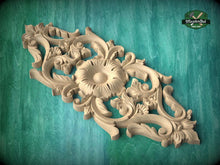 Load image into Gallery viewer, a beautifully carved wooden piece with intricate floral and leaf designs, set against a green background.