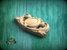 Load image into Gallery viewer, A wooden carving of an ornate, decorative piece is displayed against a green background.