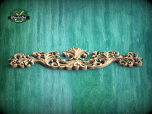 Load image into Gallery viewer, A decorative wooden carving with intricate scrollwork is displayed against a textured green background.