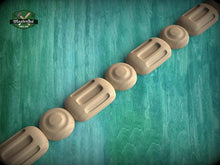 Load image into Gallery viewer, A row of wooden objects, possibly carved or shaped, arranged in a linear fashion against a green background.