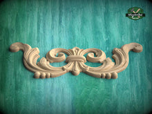 Load image into Gallery viewer, A decorative wooden carving in the shape of a scroll or fan is displayed against a green background.