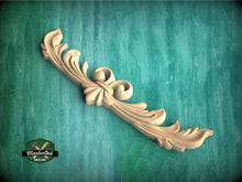 Load image into Gallery viewer, a wood carving of a flower on a green background