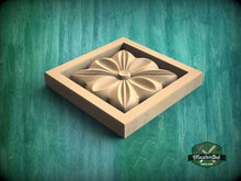 Load image into Gallery viewer, A wooden flower-shaped cutout is displayed in a square wooden frame against a green background.