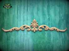 Load image into Gallery viewer, a decorative wooden carving on a green wooden surface.