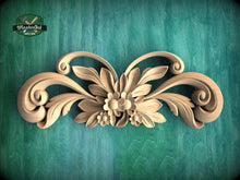 Load image into Gallery viewer, A decorative wooden carving with intricate floral and leaf designs is displayed against a green textured background.