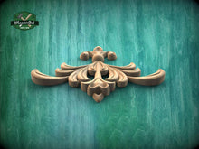 Load image into Gallery viewer, A decorative wooden carving in the shape of a flower or plant is displayed against a green textured background.