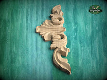 Load image into Gallery viewer, A decorative wooden carving is displayed against a green textured background.