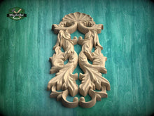 Load image into Gallery viewer, a carved wooden design with intricate leaf-like patterns, set against a green background.