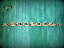 Load image into Gallery viewer, a decorative wooden molding with a curved design on a green background.