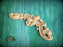 Load image into Gallery viewer, A decorative wooden carving with intricate swirls and curves is displayed against a teal background.