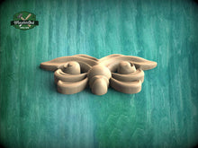 Load image into Gallery viewer, A wooden carving of a butterfly-like insect is displayed against a green background.